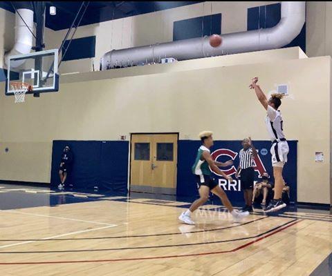 Senior Gavin Crown shoots a 3-pointer during a tournament this fall.