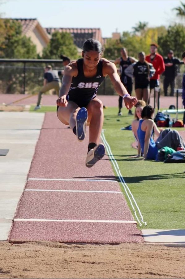 Grace Cunningham (12) springs into the air for her high jump event. 