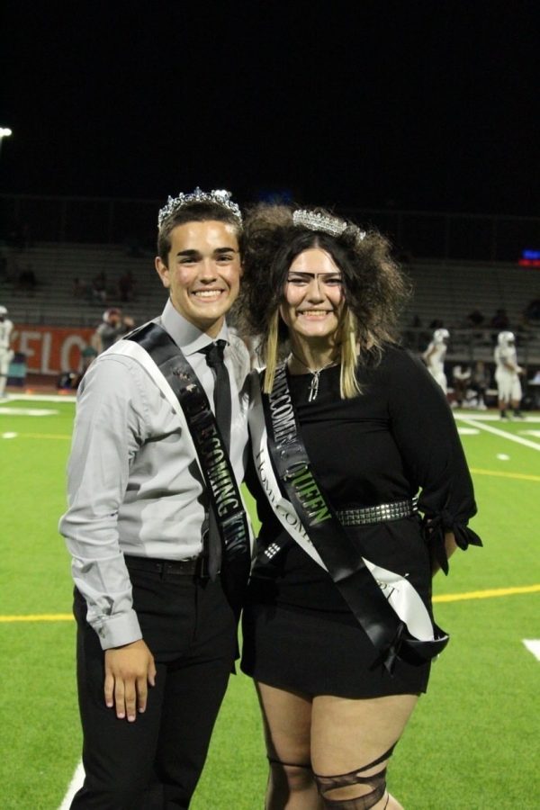After winning royalty, seniors homecoming king John Hooper and queen Alyssa Lalos beam with excitement during halftime of the homecoming game on Oct. 1.