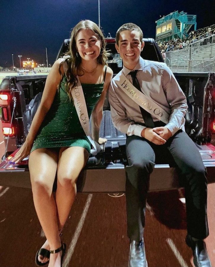 During halftime at the homecoming game on Friday, Oct. 1, seniors Carley Garza and John Hooper drive around the track on the senior homecoming floats.