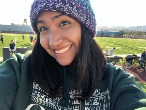 At the beginning of the school day, senior drum major Nicole Garcia enjoys the morning sunshine during her band class from the view of her scaffolding. 