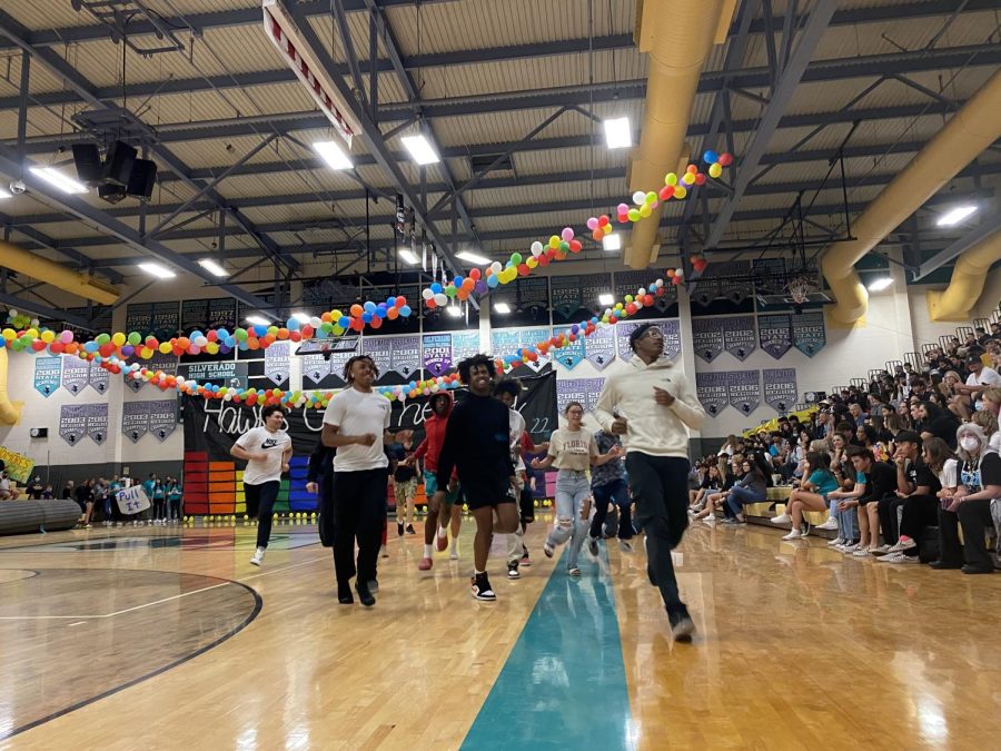 During the Hawkfest Assembly on March 25, students selected from the crowd play a game of Bop It in the gym.