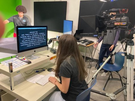 Junior Giselle Santoyo operates the teleprompter while her classmates record the announcements.