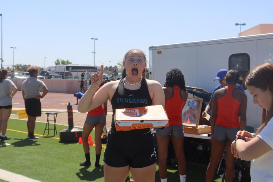 Senior Brooke Kramer shows her excitement after she wins a pizza for the throwers relay race during the Skyhawk Invitational April 15.