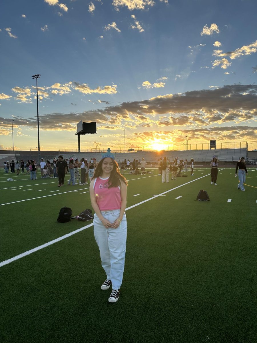 Giselle Santoyo soaks up the sunrise on the football field at senior sunrise Aug. 11.
