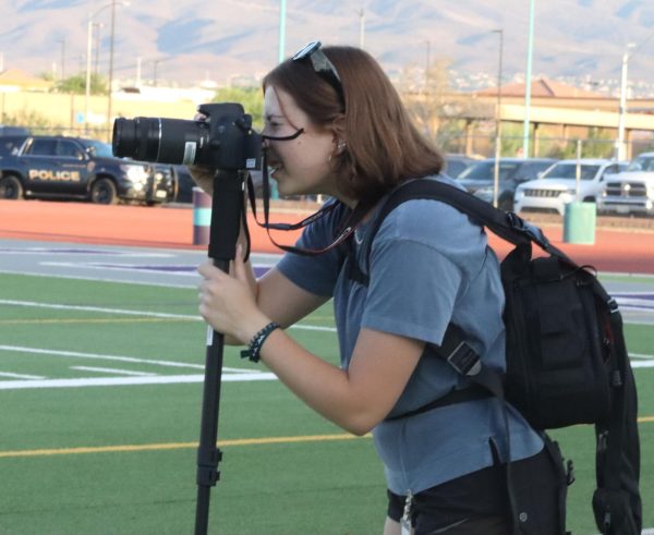 Venicia Guariglia takes pictures for the yearbook at the homecoming game against Basic International Academy on Aug. 25.