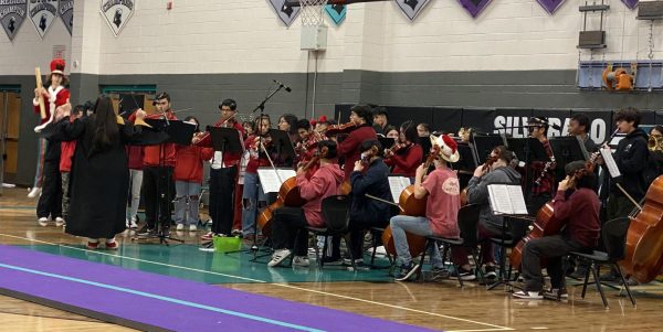 The Silverado Chamber Orchestra supports UNLV at the Dec.  8 winter assembly by wearing red.