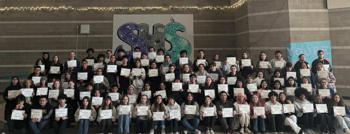Students stand together and show off their certificates they received at the Quarter 2 Straight A breakfast on Jan. 26.