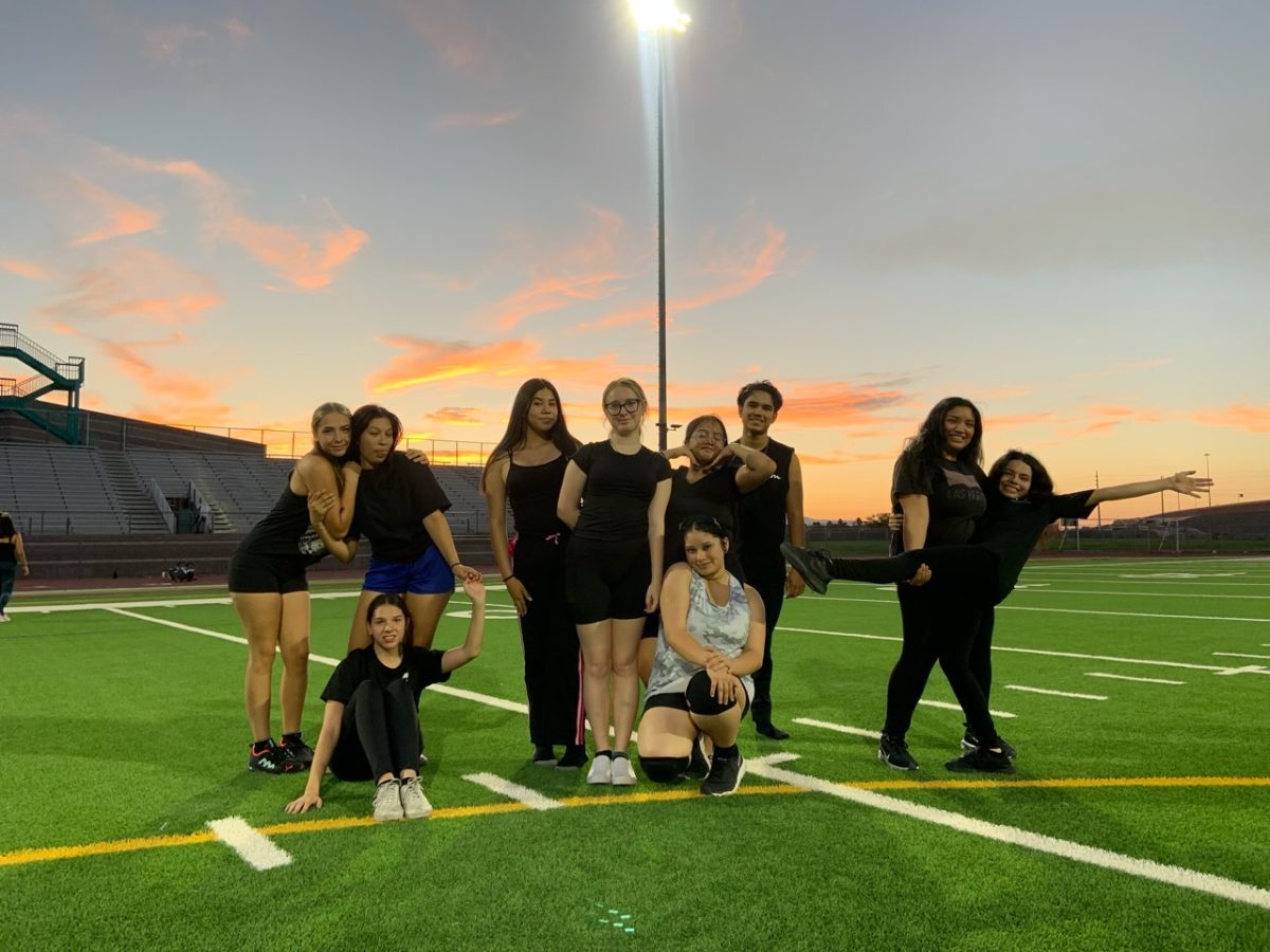 The 2023-2024 Color Guard poses at dusk on July 28 during summer band camp.